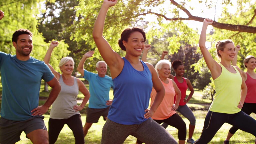 Diverse individuals participating in an outdoor fitness class, representing community and holistic wellness.